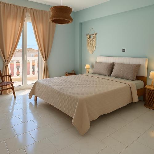 a bedroom with a large bed and a large window at Ioli's Apartments Zante in Alykes