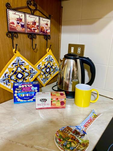 a kitchen counter with a tea pot and a cup at La Casa del Sole in Corleone