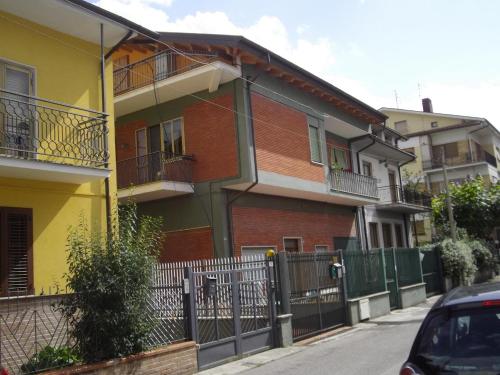 a building with a fence next to a street at B&B 'Tra i due Parchi'' in Avezzano