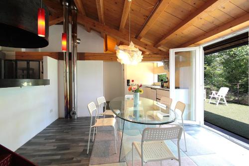 a dining room with a glass table and chairs at Silea Apartments, Pool, Garden, Treviso in Silea