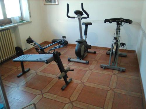 a gym with three exercise bikes on a tile floor at B&B 'Tra i due Parchi'' in Avezzano