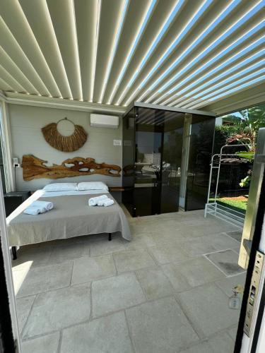 a bedroom with a bed on a patio at Villa Dalesco in Leverano