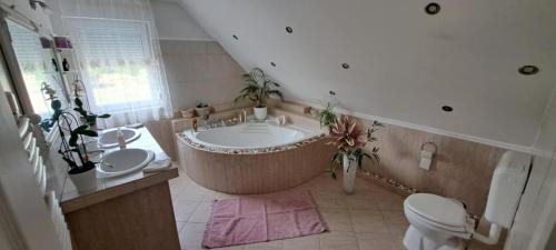 a large bathroom with a large tub and a toilet at Shining Home 
