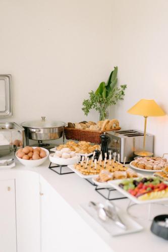 a buffet of food on a counter in a kitchen at Apollo Palm Hotel in Athens