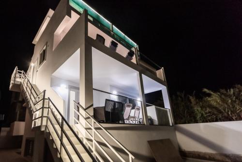 a white building with some chairs on it at night at Sinani Villas Rhodes - Afantou Private Retreats in Afantou