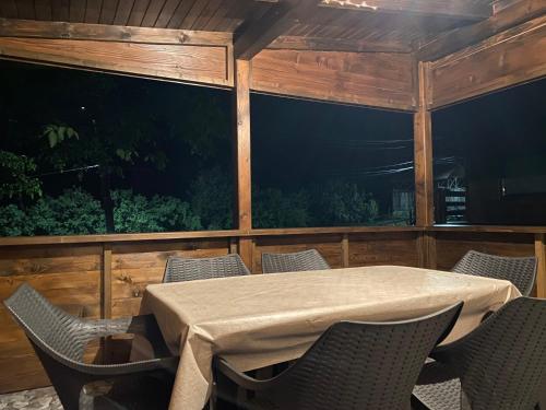 a room with a table and chairs and a large window at Bungalouri Olanesti in Băile Olăneşti