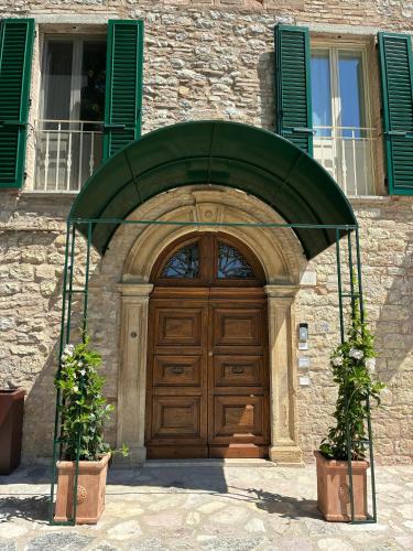 a wooden door in front of a building at Cantina Semonte Wine Resort in Gubbio