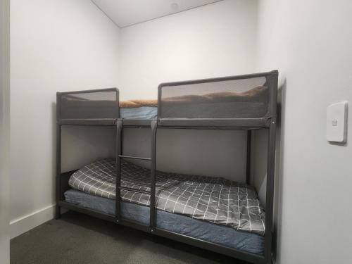 a black bunk bed in a room at Skyline Comfort - Sydney Olympic Park in Sydney