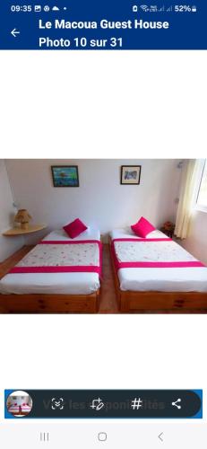 two twin beds in a room with avertisementforgrimgrimgrimgrimgrimgrim at Le Macoua Guest House in Nouvelle Découverte