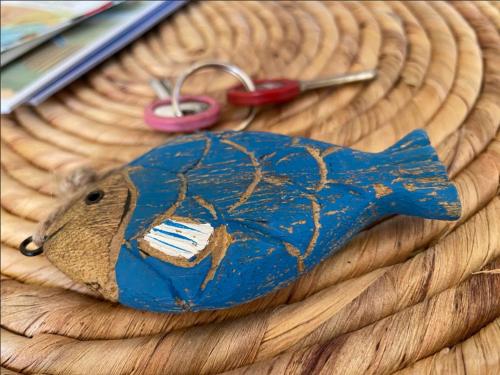 a blue bird figurine on a table with a pair of scissors at Brise des dunes in Saint-Pierre-dʼOléron