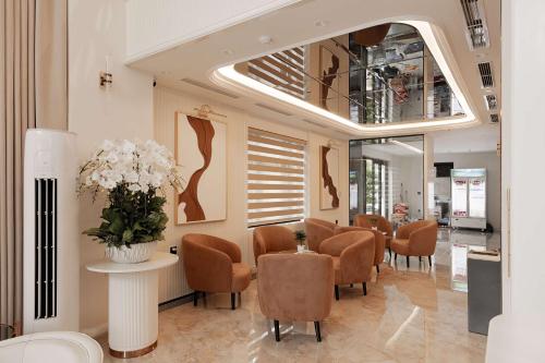 a waiting room with chairs and a table and flowers at The World Hotel in Móng Cái