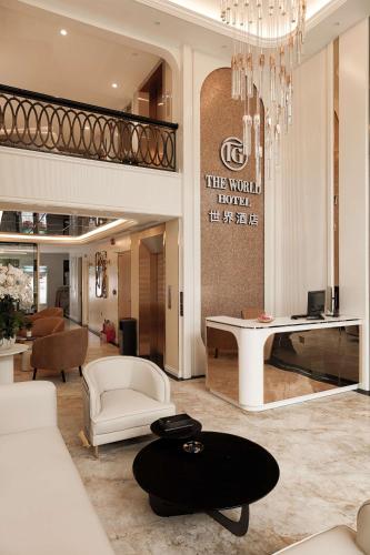 a lobby with a chandelier and a living room at The World Hotel in Móng Cái