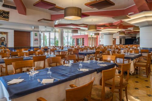 a banquet hall with blue tables and chairs at Hotel Antares Sport Beauty & Wellness in Villafranca di Verona