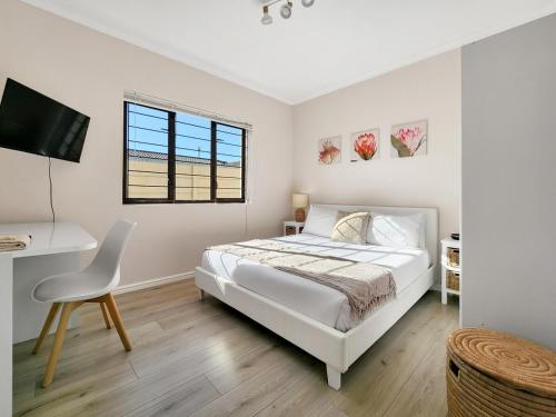 En eller flere senge i et værelse på Tranquil Garden Cottage