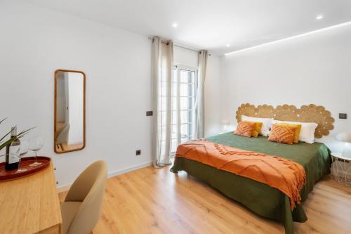 a bedroom with a large bed and a mirror at Mae Joana pool&beach Faro villa in FAO