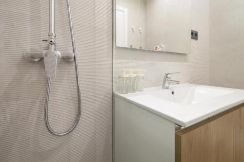 a bathroom with a shower and a sink at Mae Joana pool&beach Faro villa in FAO