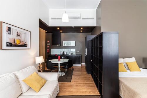 a bedroom with a bed and a living room at Well-Located Studio with Smart Space in Lisbon