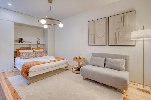 a bedroom with a bed and a chair at OPORTO GUEST Downtown Escape in Porto
