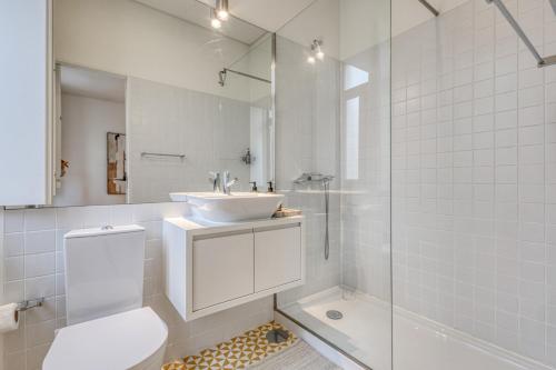 a bathroom with a sink and a toilet and a shower at OPORTO GUEST Downtown Escape in Porto
