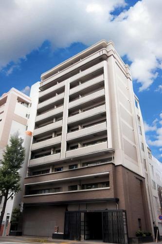 a large white building with a sky at Hotel ROI 博多 in Fukuoka