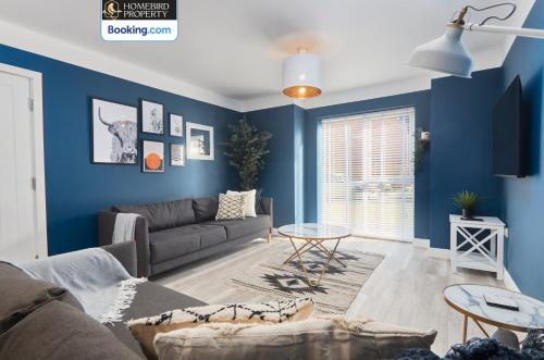 a living room with blue walls and a couch at Spacious 4BDR House By Homebird Property Management Short Lets & Serviced Accommodation Leeds With Private Parking & Garden in Leeds