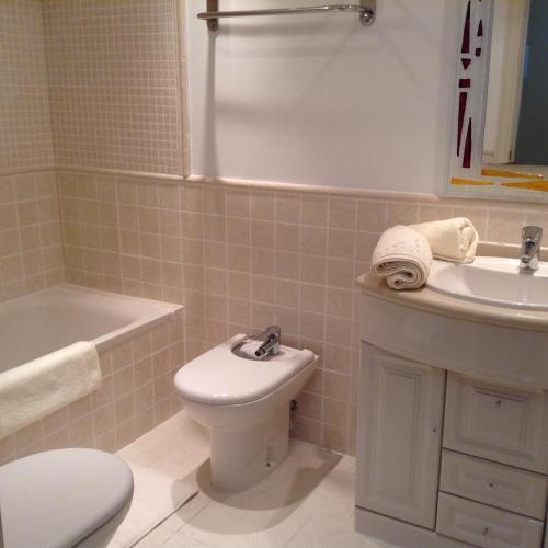 a bathroom with a white toilet and a sink at Benidorm La Cala Sidney in Cala de Finestrat