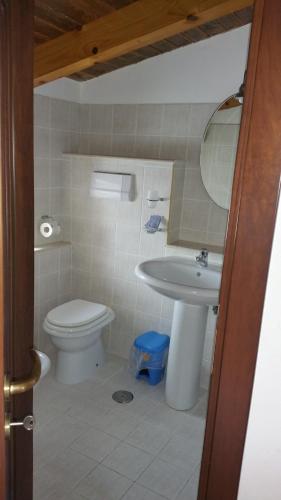 a bathroom with a toilet and a sink at Residence Albachiara in Marina di Camerota