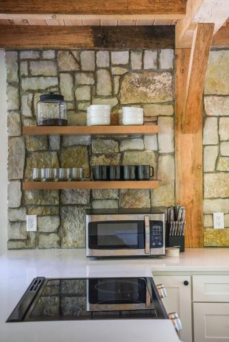 a microwave oven sitting on top of a kitchen counter at Lux Chalet 4 Bd Fireplace HotTub AC Pet Friendly in Killington