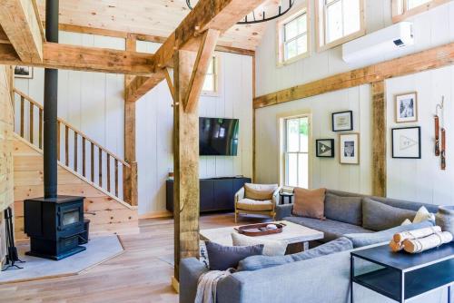a living room with a couch and a stove at Lux Chalet 4 Bd Fireplace HotTub AC Pet Friendly in Killington