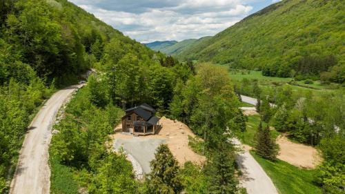 an aerial view of a house in the middle of a mountain at Lux Chalet 4 Bd Fireplace HotTub AC Pet Friendly in Killington