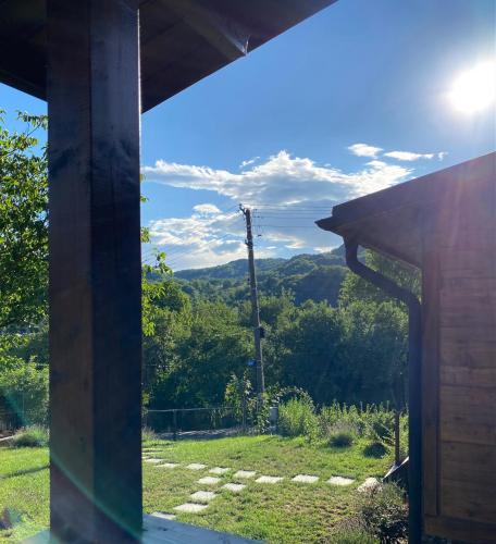 a view of the mountains from the porch of a house at Bungalouri Olanesti in Băile Olăneşti