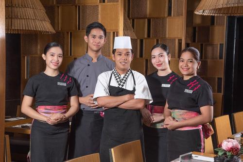 a group of people standing next to a chef at Astoria Plaza in Manila