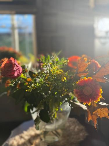 a vase filled with flowers on a table at Bed & Breakfast Yerseke in Yerseke