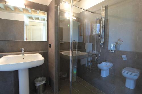a bathroom with a sink and a toilet and a shower at Silea Apartments, Pool, Garden, Treviso in Silea