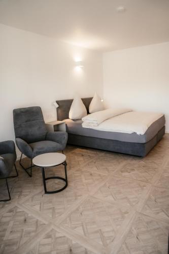 a bedroom with a bed and a couch and a table at EmsQuartier in Norderney