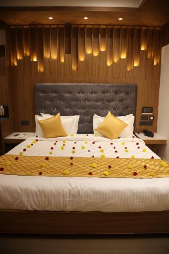 a bedroom with a large bed with flowers on it at Hotel Time Square -Gandhiji Road, Old Bus Stand, Opp clock Tower ,Thanjavur in Thanjāvūr