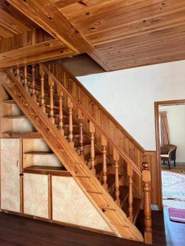 a wooden staircase in a home with a wooden ceiling at Shangrilla House Murree, Bhurban in Murree
