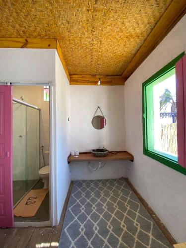 a bathroom with a toilet and a window at Pousada Casa Matriz in Itabirito