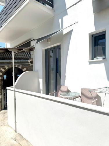 a balcony with two chairs and a table at Kirki Rooms by the sea in Parikia