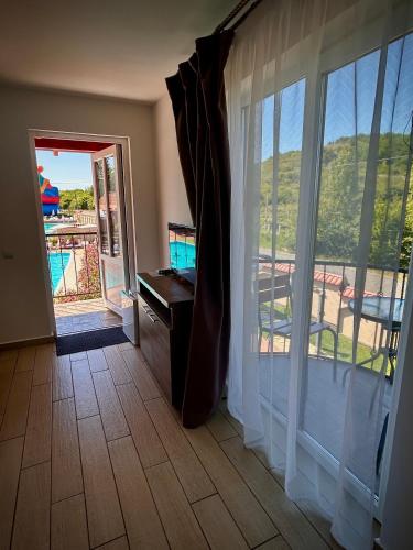 a room with a large window with a view of a balcony at Гостинний дім Александрія in Berehove