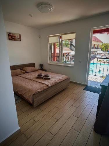 a bedroom with a bed and a view of a pool at Гостинний дім Александрія in Berehove