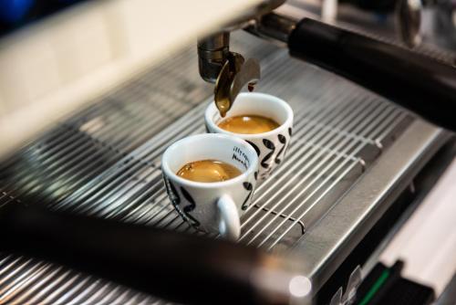 two cups of coffee are being poured into at Indipendent House in the historical city center in Varese