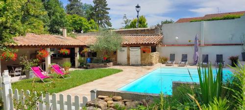a house with a swimming pool in a yard at Gîte La Ferme De Musan in Chatuzange-le-Goubet