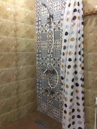 a shower in a bathroom with a shower curtain at Appart face à la mer Garden Beach Sidi Rahal plage in Sidi Rahal