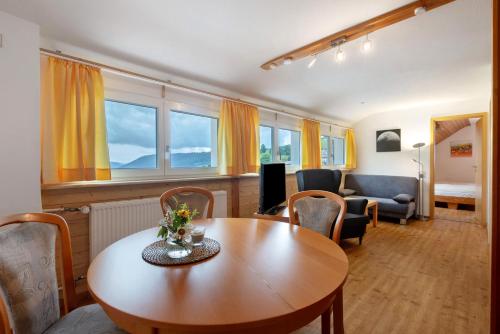 a living room with a table and chairs and a couch at Pension Birgit in Todtnauberg