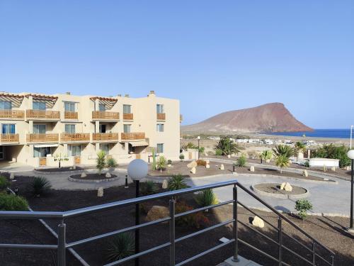 a view of the hotel and the beach from the balcony at Spacious 2 Bedroom Flat in Playa de la Tejita in La Tejita