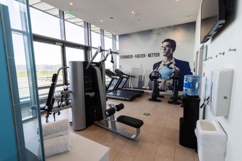 a gym with a poster of a man sitting in a chair at Clarion Hotel Bergen Airport in Bergen