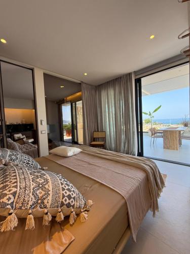 a bedroom with a large bed with a view of the ocean at Nava Sol Apartment in Vlorë
