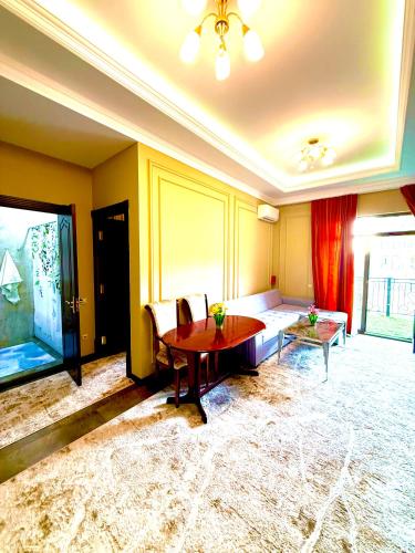 a living room with a table and a couch at Boulevard Tashkent City 02 in Tashkent