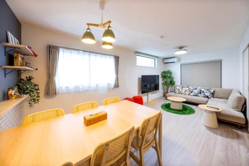 a living room with a table and a couch at Amp Flat Dazaifu Ishizaka in Dazaifu